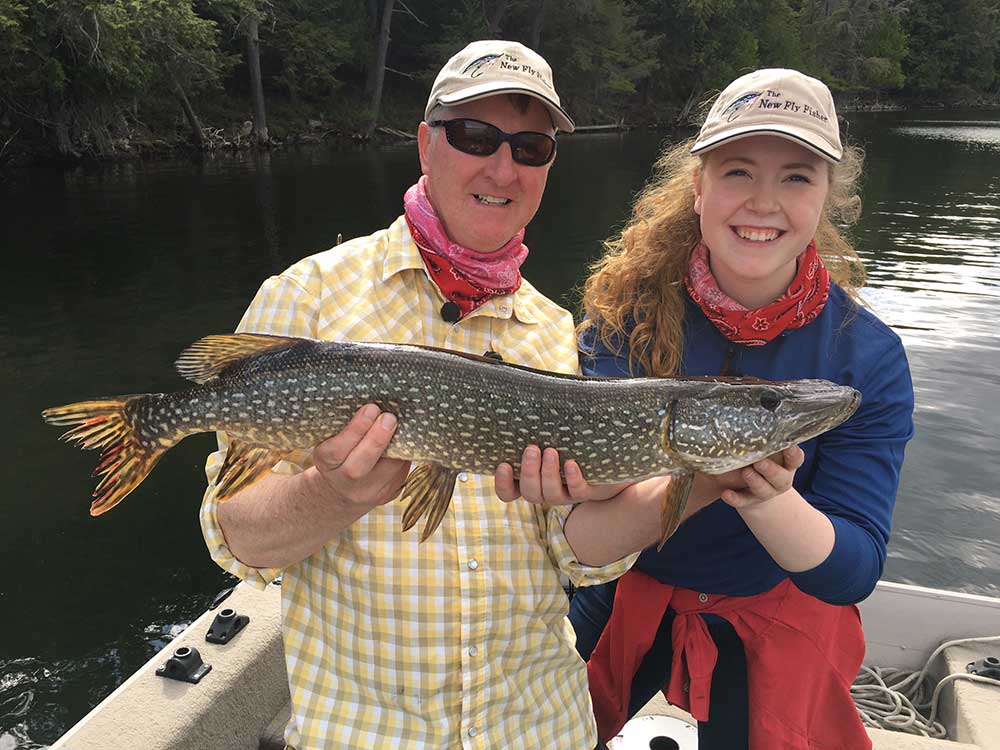father and daughter fishing northern pike