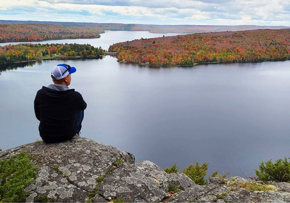 hiker overlooking view of lake