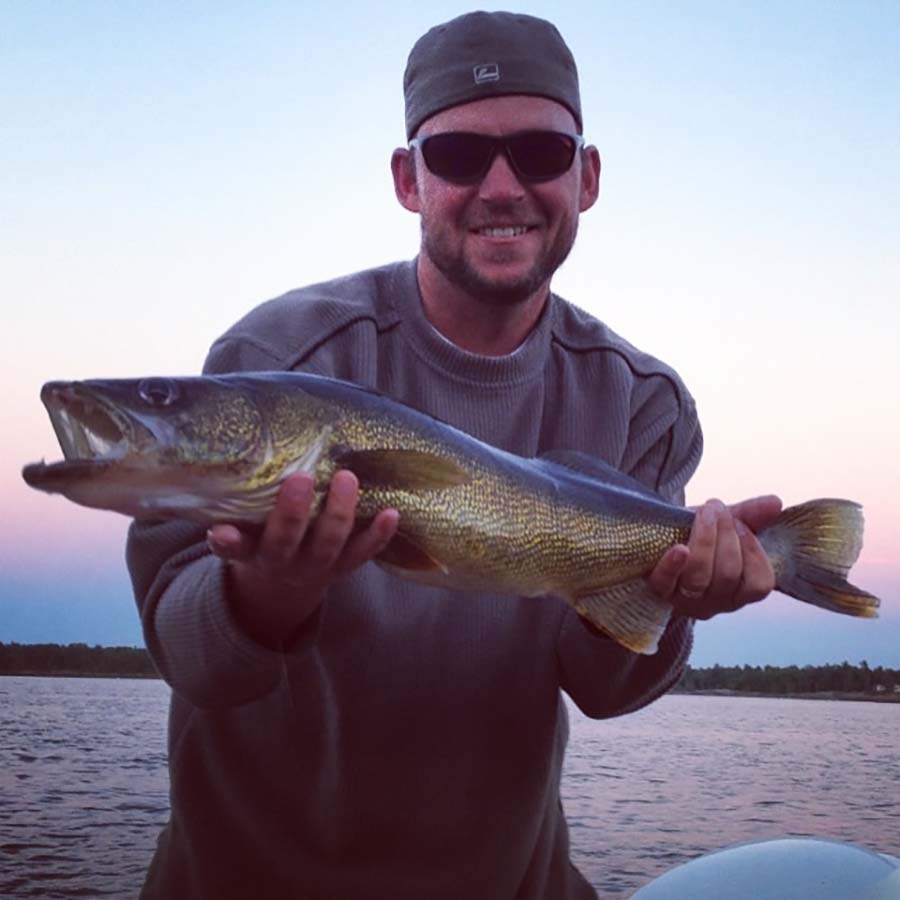 angler holding walleye