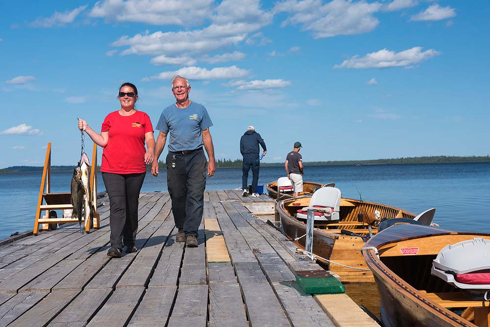anglers with fish on a dock