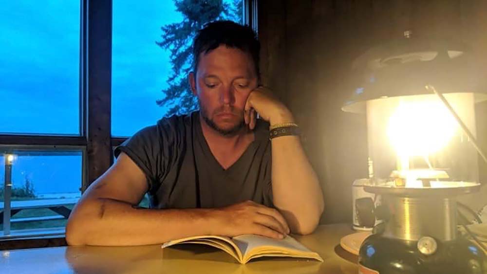 reading a book by lamp light