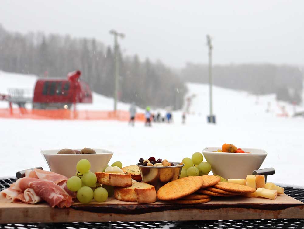 charcuterie board overlooking ski hill