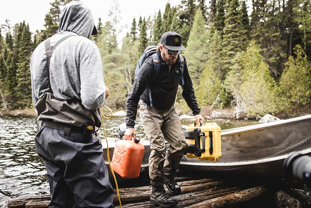 anglers carrying fuel cans