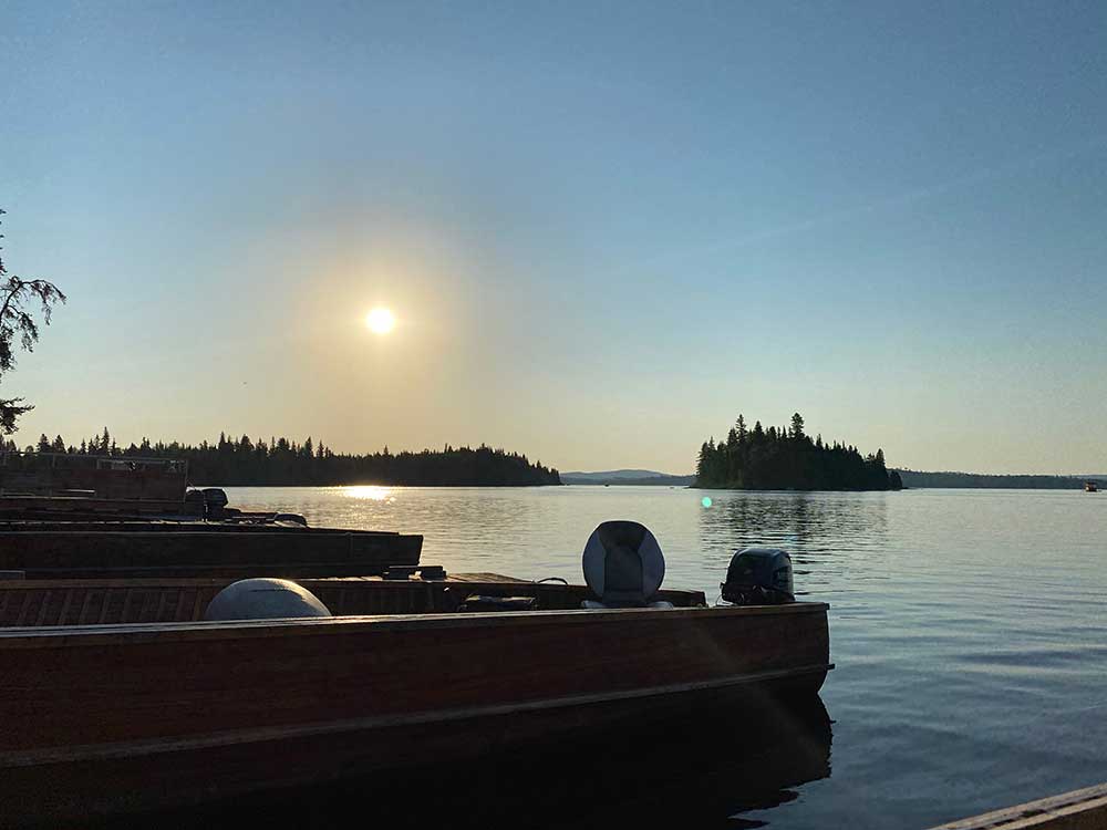 sunset over boats and lake