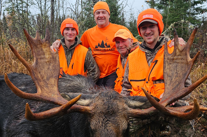 group of hunters with harvested moose